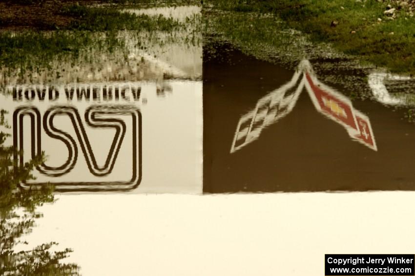 The Corvette Bridge reflected in a puddle at turn 6.