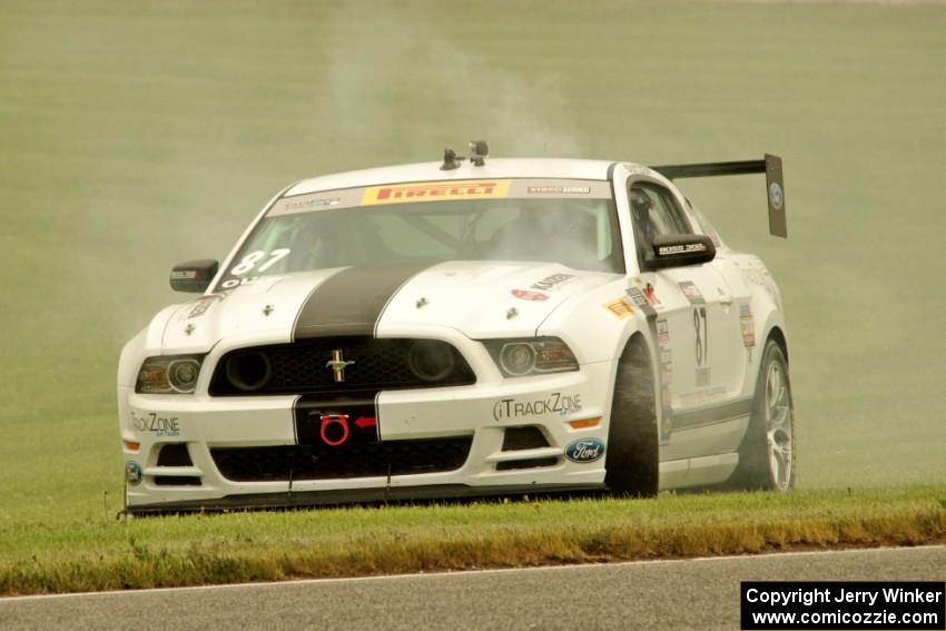 Chris Outzen's Ford Mustang Boss 302S comes to a stop after losing the engine on the first lap.