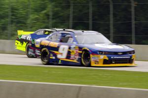 Justin Marks' Chevy Camaro passes by Chase Elliott's Chevy Camaro