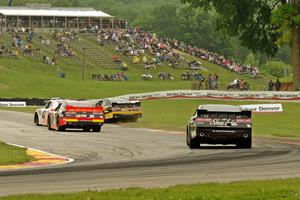 Dylan Kwasniewski's, Brendan Gaughan's (in the dirt), Ty Dillon's and Brian Scott's Chevy Camaros battle at turn 6.