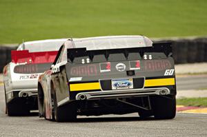 Chris Buescher's Ford Mustang chases Alex Tagliani's Dodge Challenger