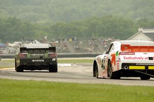 Sam Hornish, Jr.'s Toyota Camry ahead of Dylan Kwasniewski's Chevy Camaro