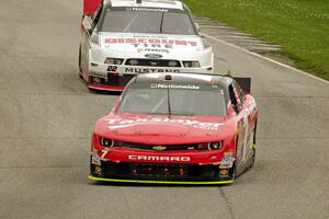 Regan Smith's Chevy Camaro and Alex Tagliani's Dodge Challenger