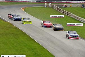 Trevor Bayne's Ford Mustang leads five other cars into turn 7.