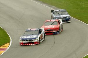 Trevor Bayne's Ford Mustang, Ryan Reed's Ford Mustang and Elliott Sadler's Toyota Camry