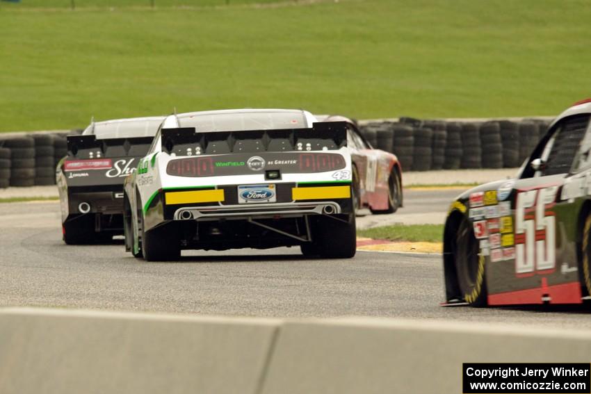 Chris Buescher's Ford Mustang ahead of Brian Scott's Chevy Camaro, Dakoda Armstrong's Ford Mustang and Andy Lally's Chevy Camaro