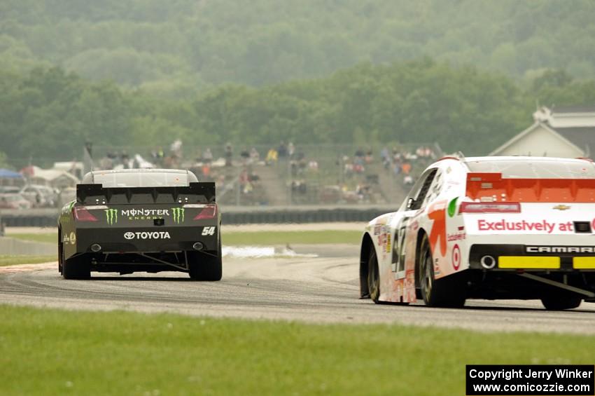 Sam Hornish, Jr.'s Toyota Camry ahead of Dylan Kwasniewski's Chevy Camaro