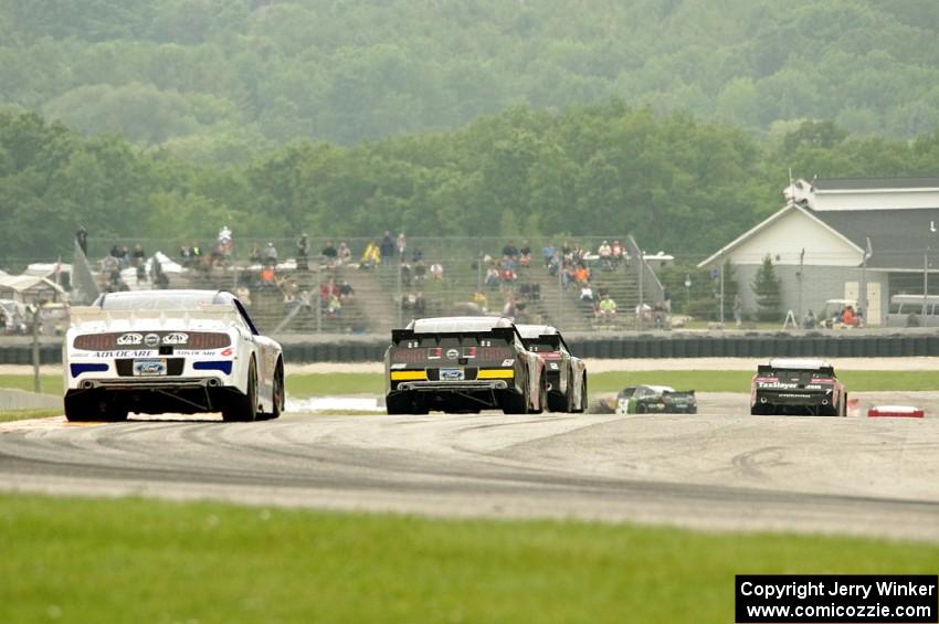 Trevor Bayne's Ford Mustang brings up the rear of a pack at turn 7.