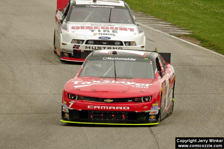 Regan Smith's Chevy Camaro and Alex Tagliani's Dodge Challenger