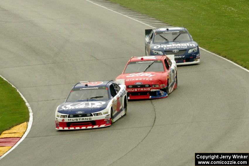 Trevor Bayne's Ford Mustang, Ryan Reed's Ford Mustang and Elliott Sadler's Toyota Camry