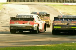 Brendan Gaughan's, Kevin O'Connell's and Chase Elliott's Chevy Camaros battle at turn 6 on the final lap.