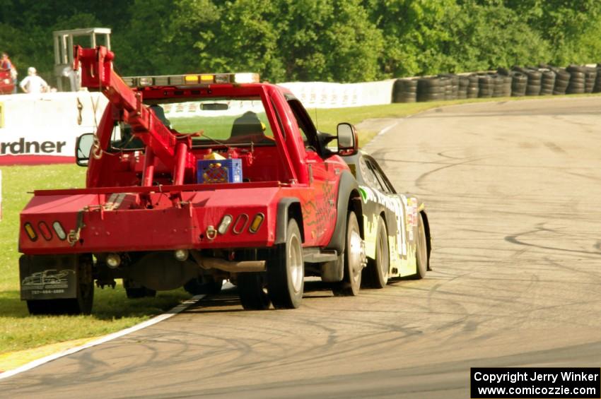 Justin Marks' Chevy Camaro is pushed off the track.