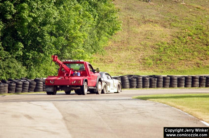 Justin Marks' Chevy Camaro is pushed off the track.