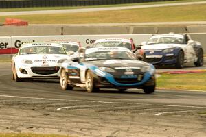 Kenton Koch and Nathanial Sparks lead the field of Mazda MX-5s through turn 8 on the second lap.