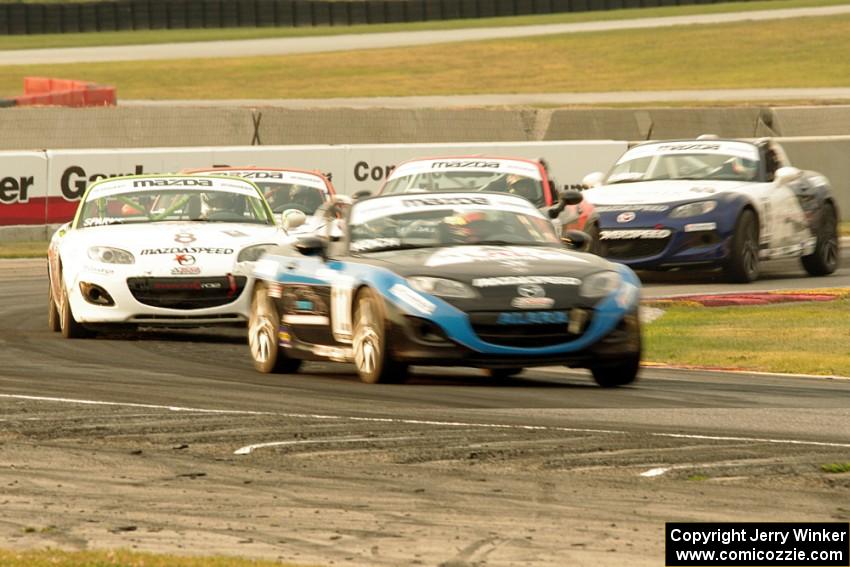 Kenton Koch and Nathanial Sparks lead the field of Mazda MX-5s through turn 8 on the second lap.