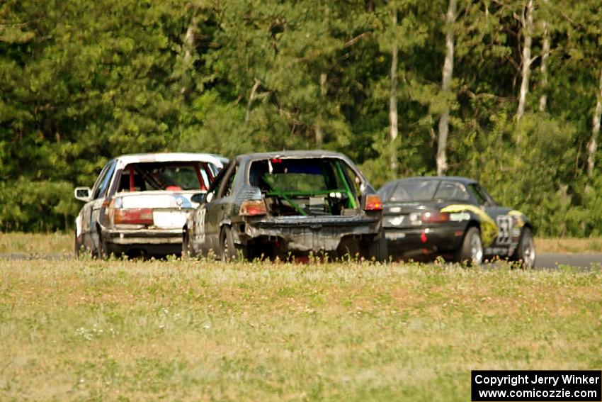 Team Party Cat Mazda Miata ahead of The Most Interesting Chumps In The World BMW 325i and Mayhem Racing Honda Civic