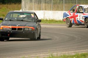 North Loop Motorsports 1 BMW 325 goes though the carousel as the British American Racing BMW 325is pits.