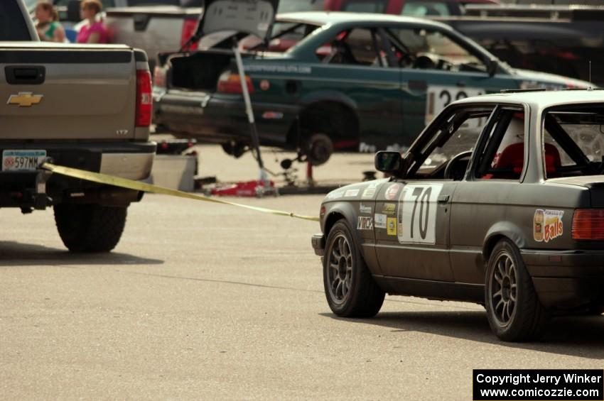 Speed Doctors BMW 325is comes back to the paddock on the end of a tow rope.