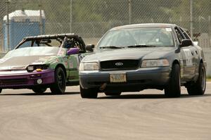 Moss Racing Ford Crown Victoria passes the Danger Zone Racing Honda CRX