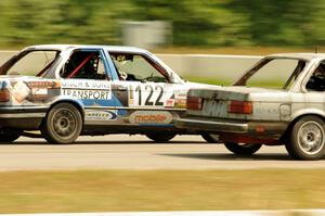 The Most Interesting Chumps In The World BMW 325i and Brainerd Bombers Racing BMW 328 go side-by-side into turn 2.