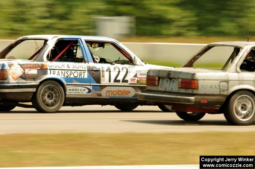 The Most Interesting Chumps In The World BMW 325i and Brainerd Bombers Racing BMW 328 go side-by-side into turn 2.