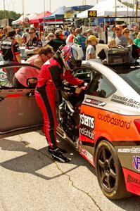 James Vance and Katherine Legge practice pits stops in their Honda Civic during the grid walk.