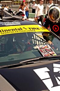 James Vance and Katherine Legge practice pits stops in their Honda Civic during the grid walk.