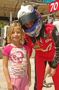 A young fan poses with Katherine Legge on the grid walk.
