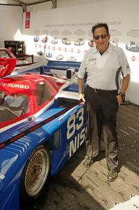 Tony Adamowicz next to the Nissan GTP ZX-T at the Nissan tent.