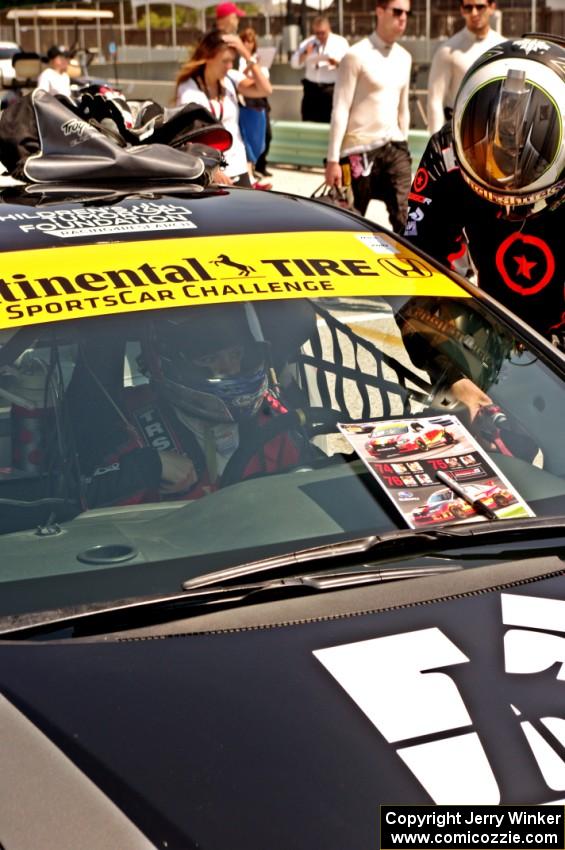 James Vance and Katherine Legge practice pits stops in their Honda Civic during the grid walk.