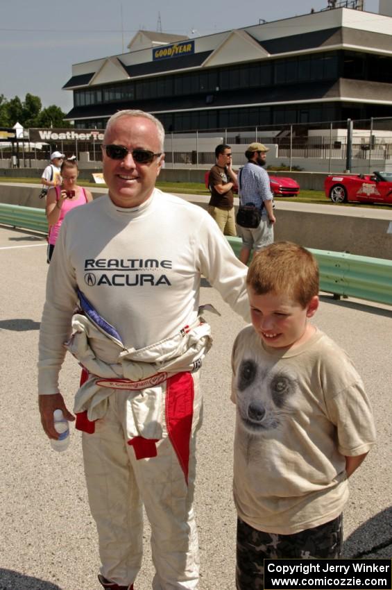 A young fan poses with Peter Cunningham on the grid walk.