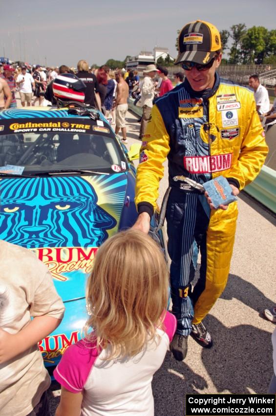 A young fan gets an autograph from Matt Plumb.