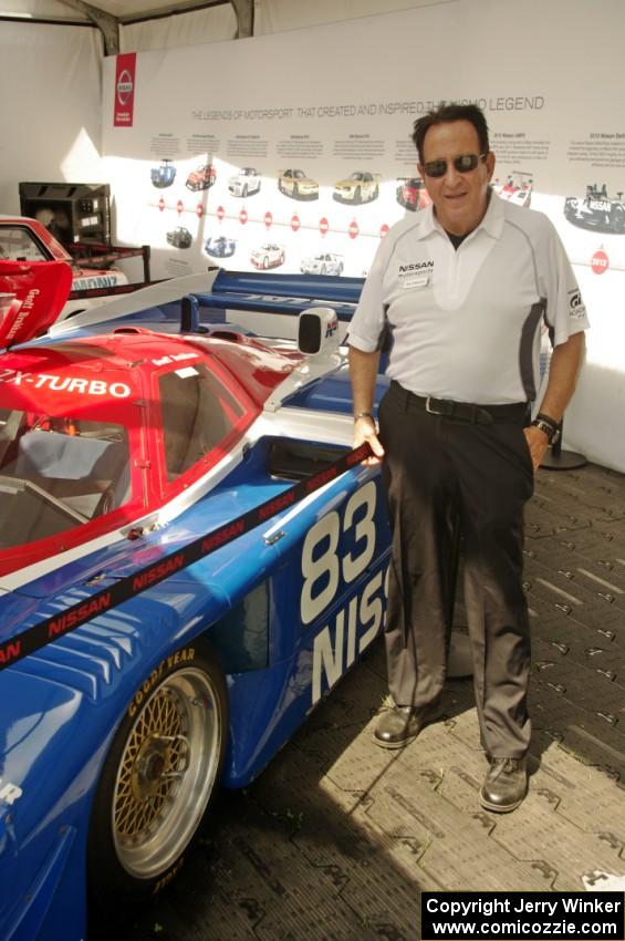 Tony Adamowicz next to the Nissan GTP ZX-T at the Nissan tent.