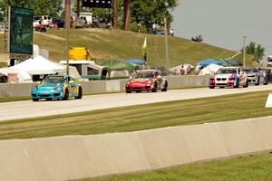 Matt Plumb / Nick Longhi Porsche 997 leads the field into turn 8.