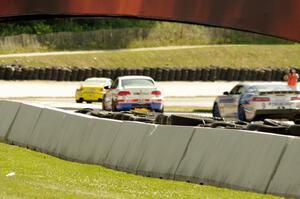 Matt Plumb / Nick Longhi Porsche 997 leads the field into the carousel.