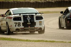 David Levine / Lucas Bize Ford Mustang Boss 302R and John Farano / David Empringham Nissan 370Z on the cool off lap