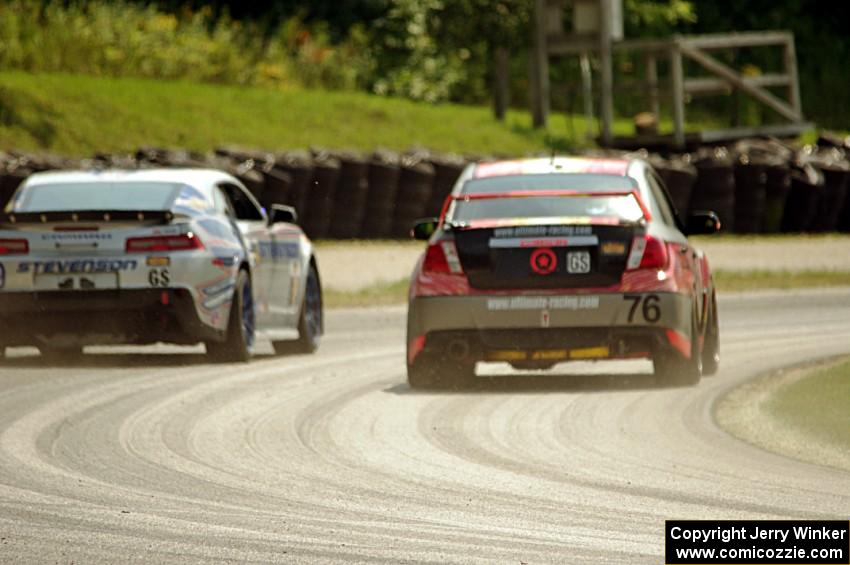 Ray Mason / Pierre Kleinubing Subaru WRX STi passes the Andy Lally / Matt Bell Chevy Camaro Z/28.R