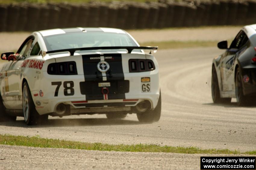 David Levine / Lucas Bize Ford Mustang Boss 302R and John Farano / David Empringham Nissan 370Z on the cool off lap