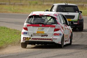 Brian Price's Honda Fit chases Jason Fichter's MINI Cooper