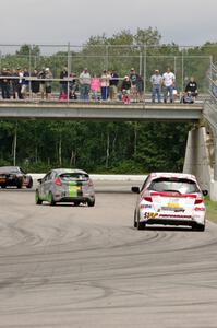 Brian Price's Honda Fit chases Ernie Francis, Jr.'s Mazda MX-5 and Nate Stacy's Ford Fiesta