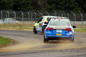 Fred Emich's VW Jetta GLI chases Michael Ashby's and Chris Holter's Mazda 2s