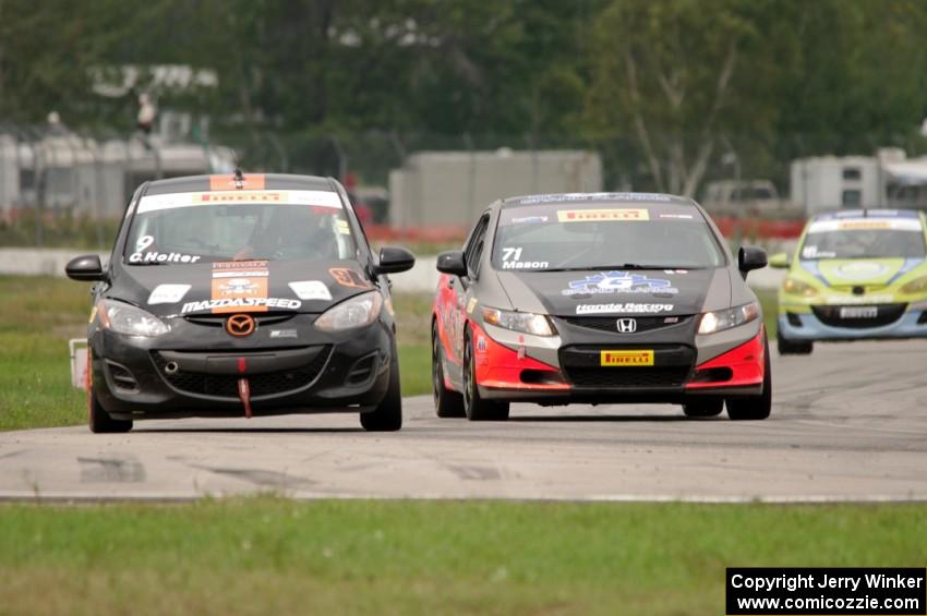 Chris Holter's Mazda 2 is passed by Ray Mason's Honda Civic Si