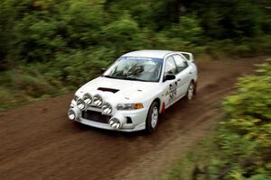 Alec Ellsworth /	Steve Kaczkowski Mitsubishi Lancer Evo IV at speed on SS1, Waptus.