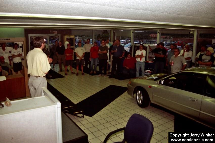 Paul Eklund speaks to rally fans at Morrie's Subaru.