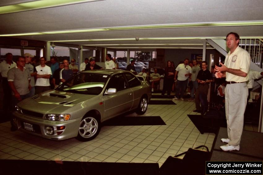 Paul Eklund speaks to rally fans at Morrie's Subaru.