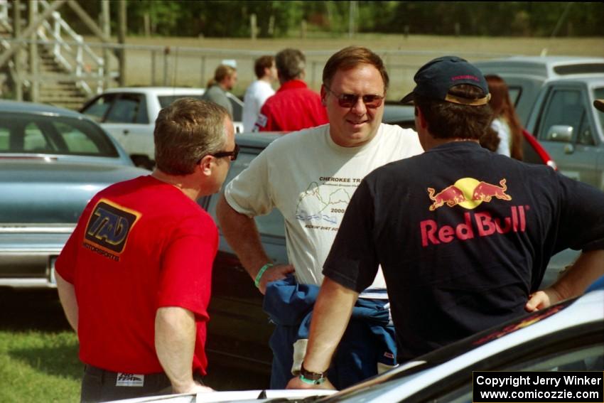 Peter Cunningham, Doug Shepherd and Paul Choiniere converse at parc expose prior to SS8, Speedway Shennanigans.