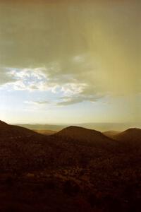 A thunderstorm rains over the mountainside.