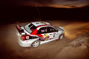 Garen Shrader / Michael Fennell Mitsubishi Lancer Evo IV just after sundown on SS2.