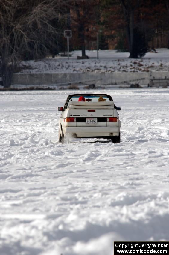 A VW Rabbit Cabriolet takes in the sunny day on the lake.