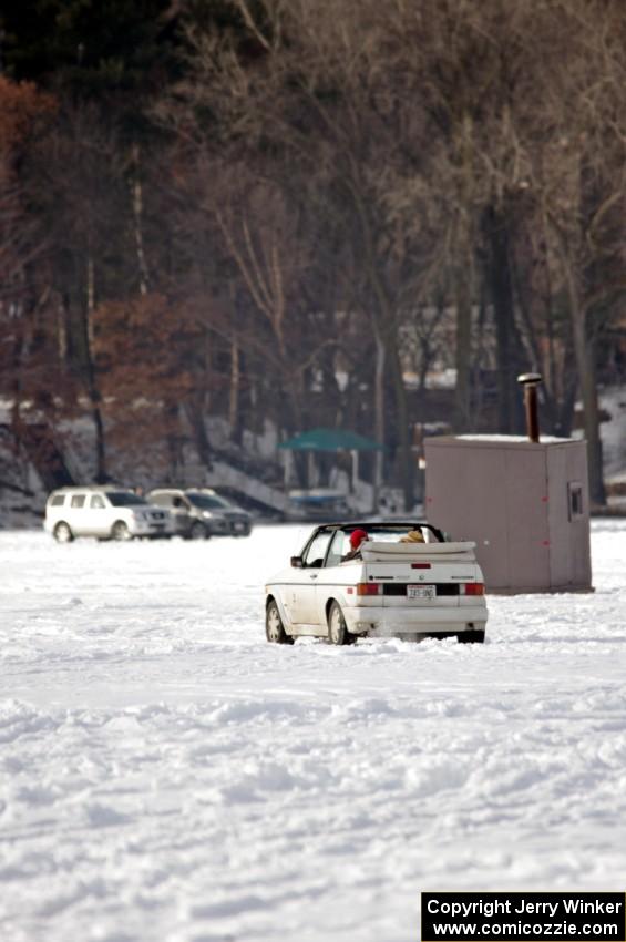 A VW Rabbit Cabriolet takes in the sunny day on the lake.